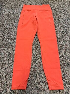 Athleta Transcend Stash Tight in Orange - Medium